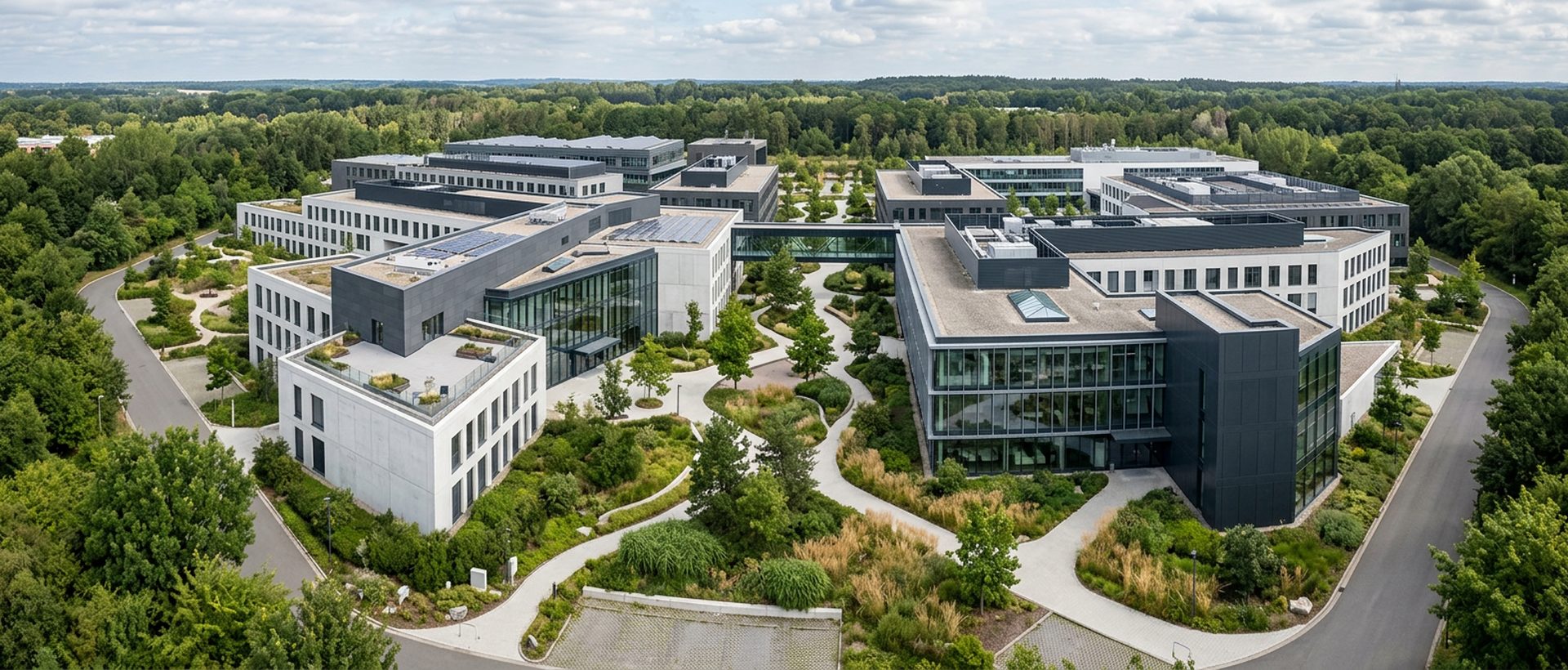 Campus tertiaire vu du ciel avec bâtiments reliés par des allées plantées